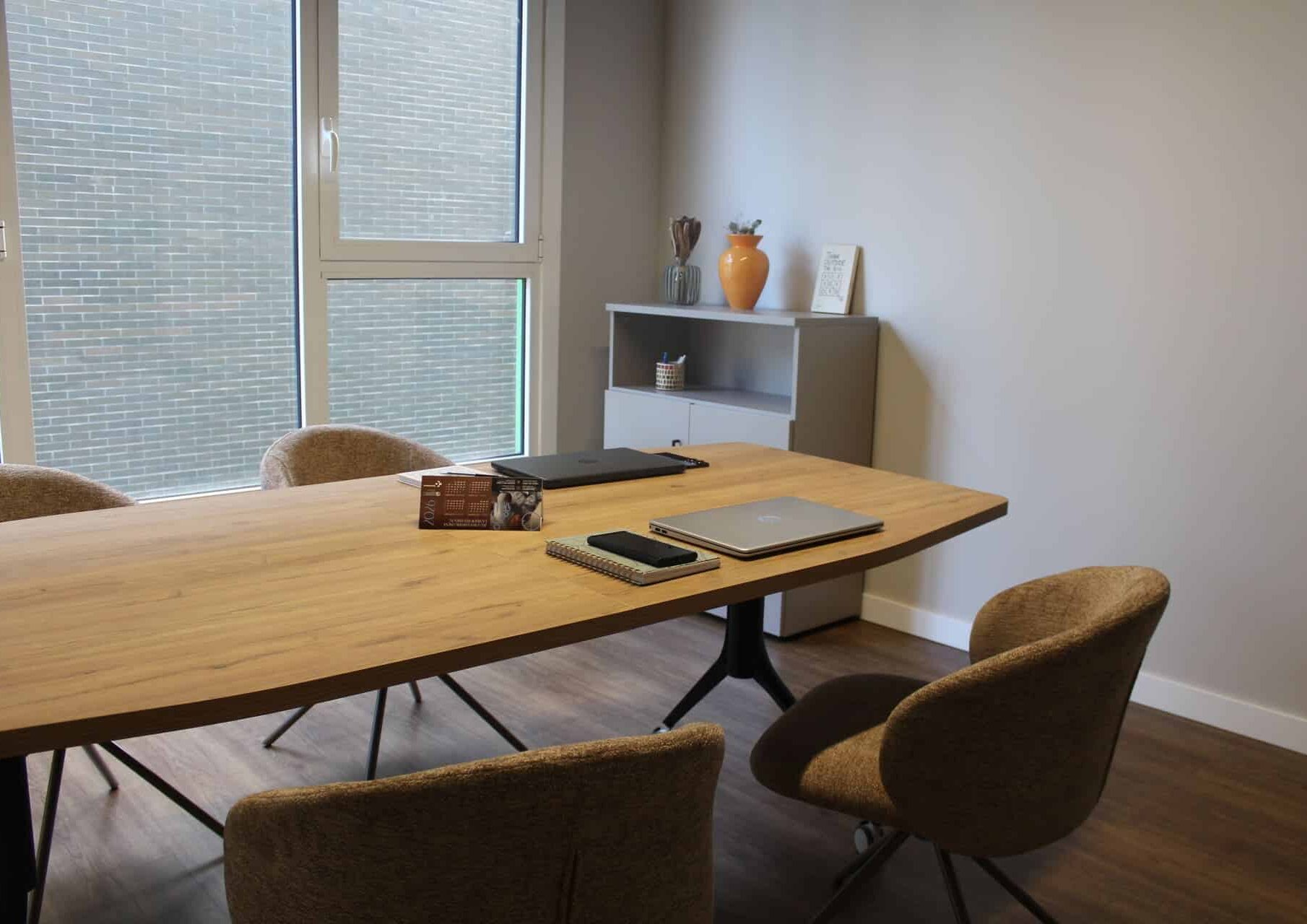 coworking-kbiak-sala-reuniones-ilimitada-amara Sala de reuniones en Coworking Kbiak en Amara para 4 personas, con mesa de madera, sillas ergonómicas y luz natural, cerca de Ayete y el Centro.